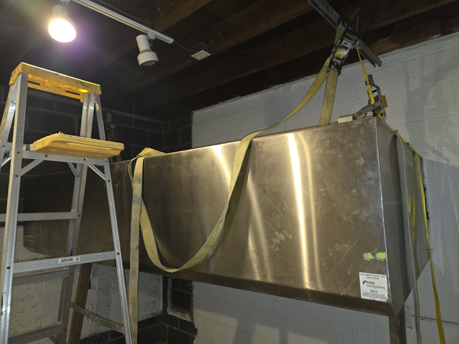 Commercial kitchen hood being installed